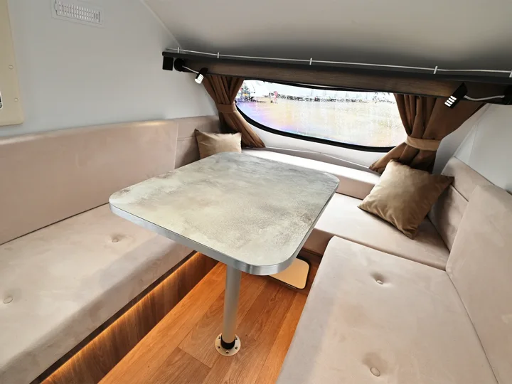 Go-Pod interior with upholstered seats and a dining table