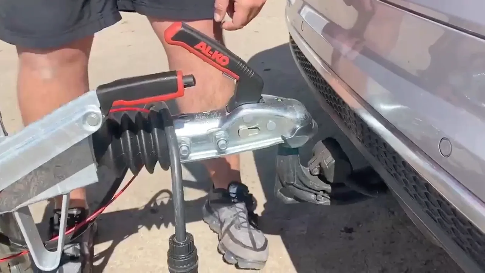 Winding the Go-Pod jockey wheel down until the coupling head attaches to the tow ball