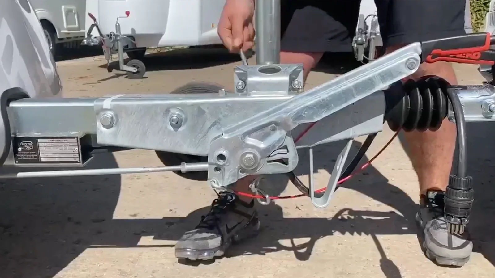 Raising the Go-Pod jockey wheel and clamping it into position before towing