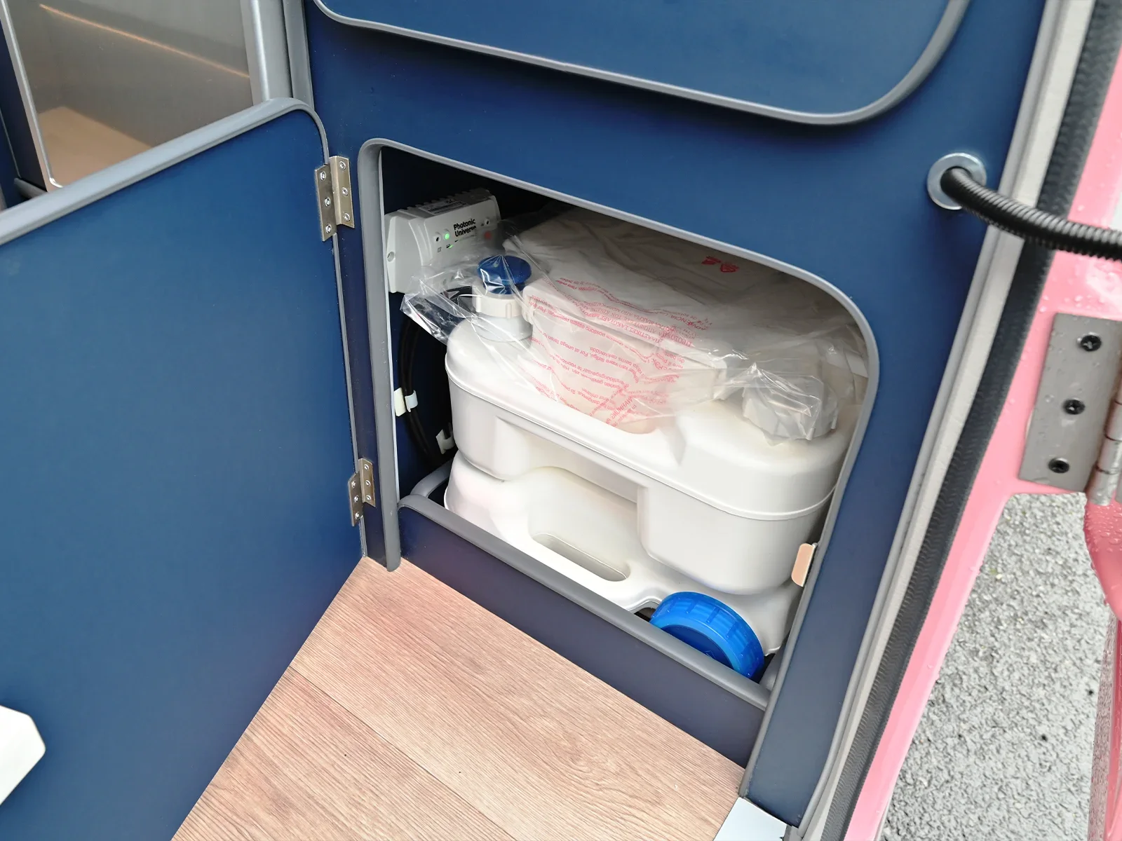 Portable camping toilet stored beneath the Go-Pod wardrobe