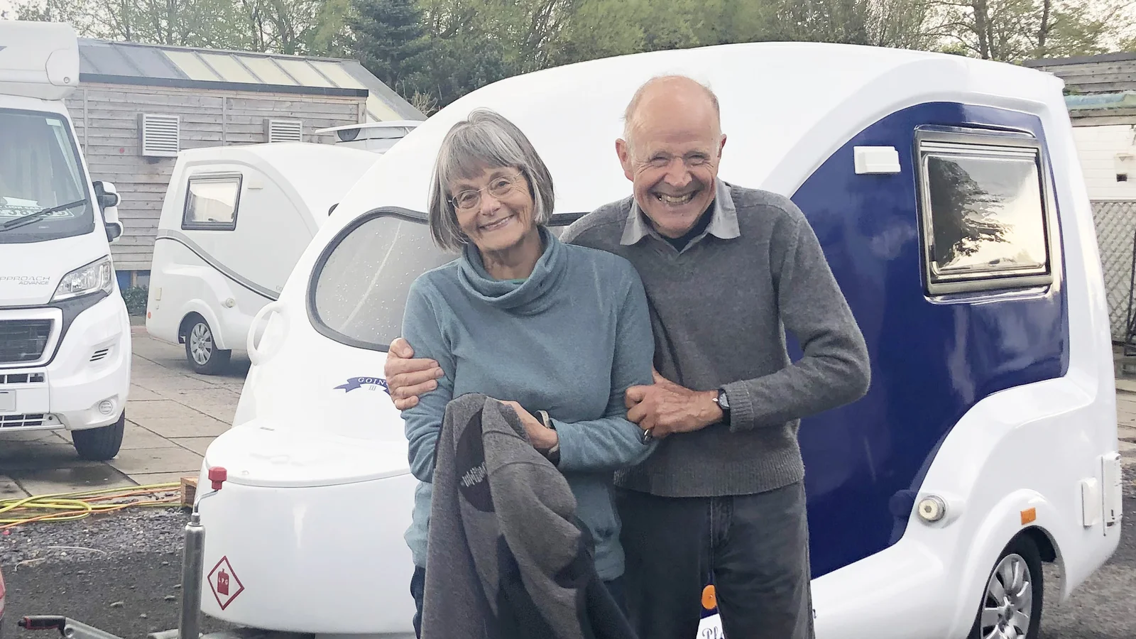 Go-Pod owners standing beside their caravan
