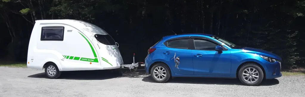 Blue Mazda with a white Go-Pod attached