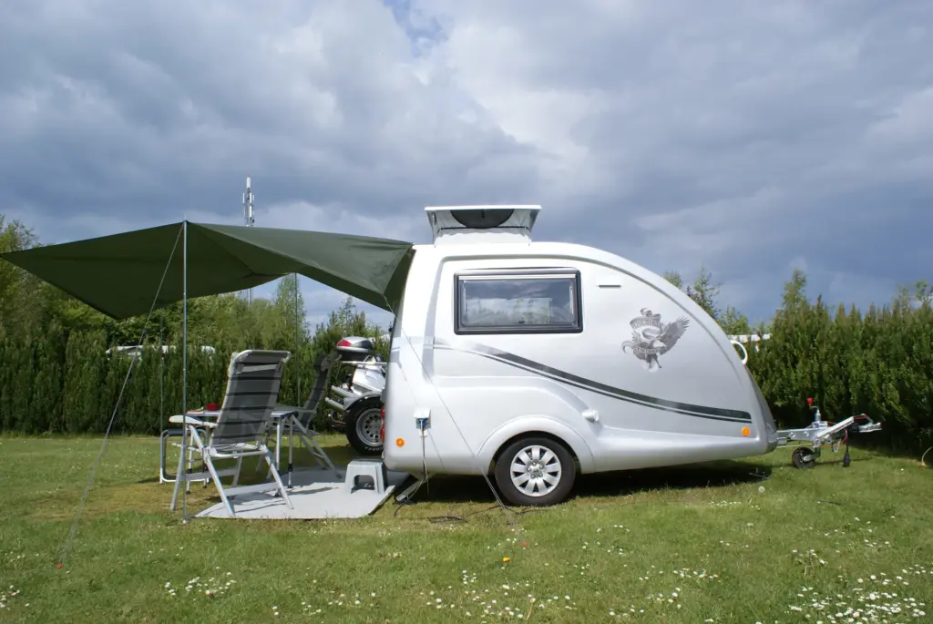 Go-Pod pitched on grass with outdoor chairs