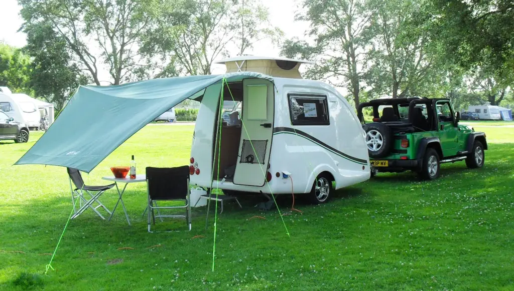 Go-Pod with a green canopy extended over a campsite pitch