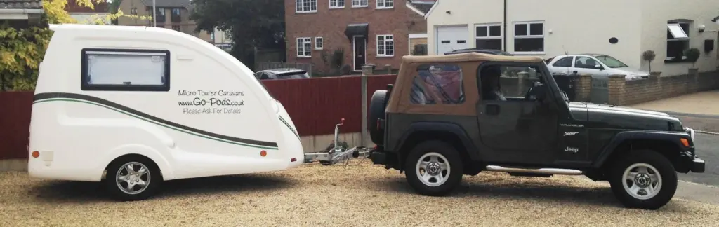 Dark Jeep with a white Go-Pod attached