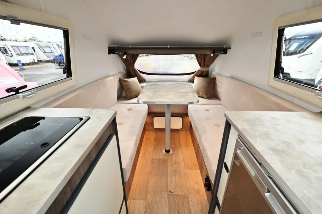 Light wood kitchen and cream seating inside a Go-Pod