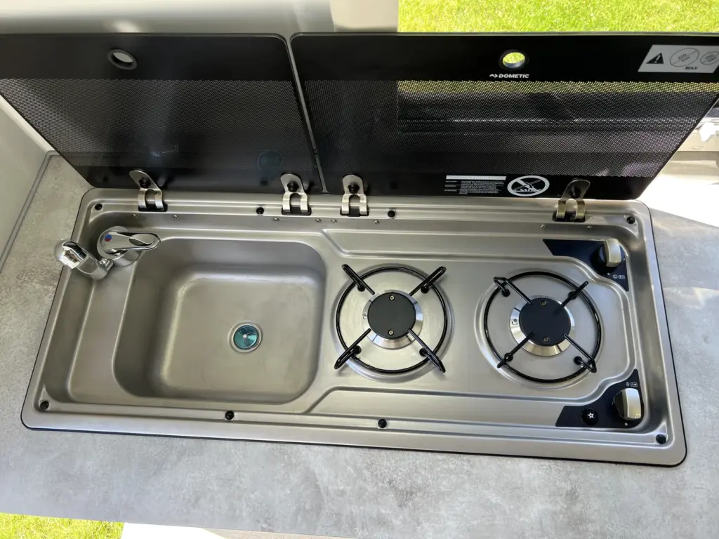 Kitchen sink beside the two-burner hob