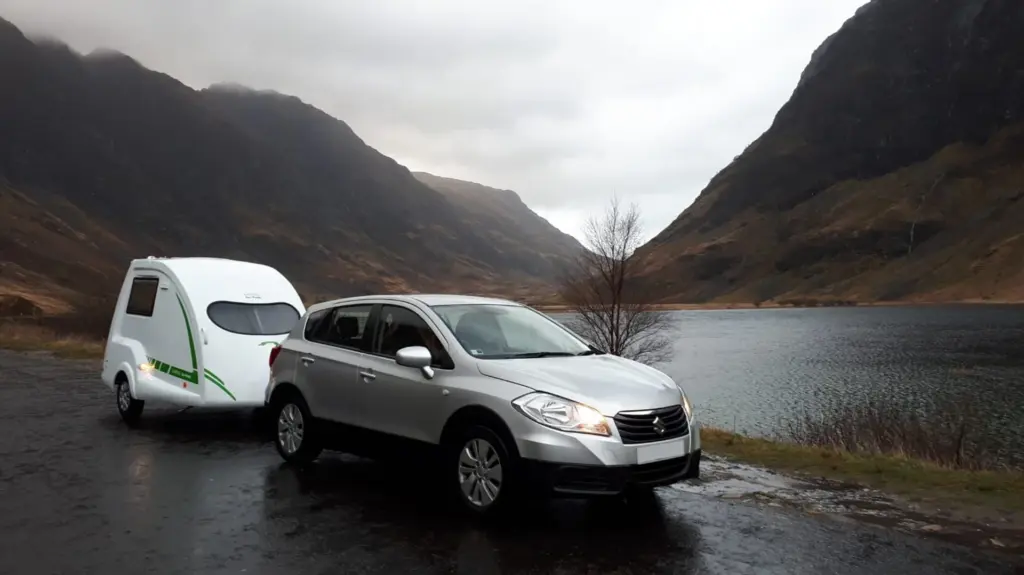Car and Go-Pod parked beside a mountain road